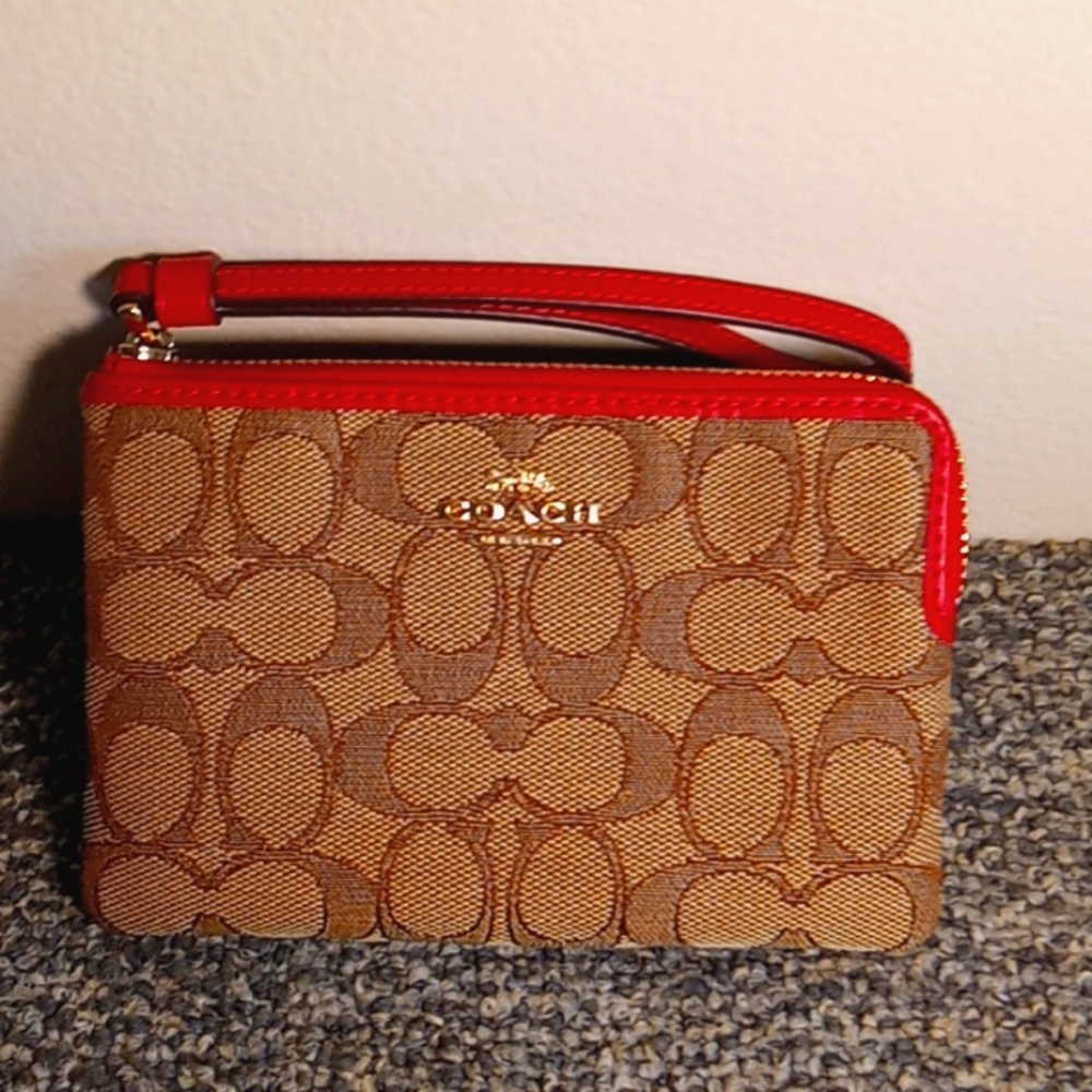 Coach brown and tan canvas zip around red leather lined women's wristlet